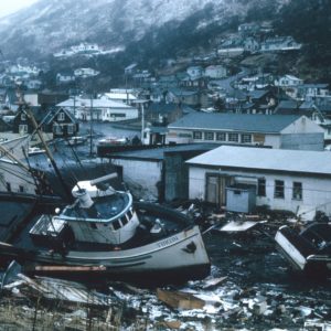 white and brown boat on black sand during daytime